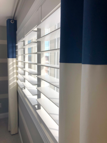 Let the sunshine in! The large louvers of shutters will invite in abundant natural light. Add a splash of color and softness with custom stationary drapes.