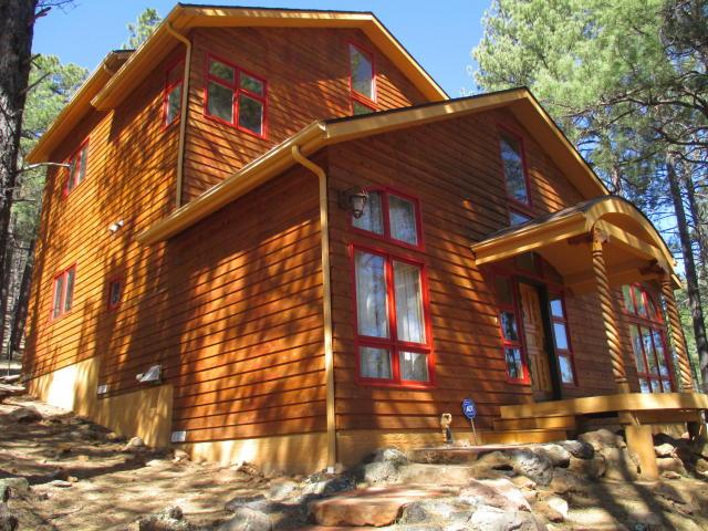 This Gorgeous custom home that is nestled in the Beautiful Ponderosa Pines offers spectacular San Francisco Peak Views and backs national forest. This is one of the most Spectacular and Unique mountain retreats that you will find in Flagstaff. The fabulous Chef's kitchen offers panoramic views of the forest and an eat in Island and custom tile work. This great home offers custom finishes from the hewn beams, posts from Toas and custom metal work from Alaska this home is truly one of a kind.