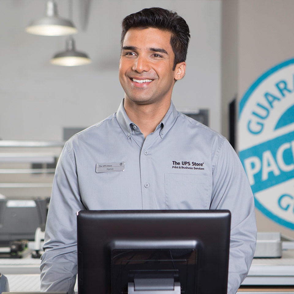 Smiling associate behind the counter