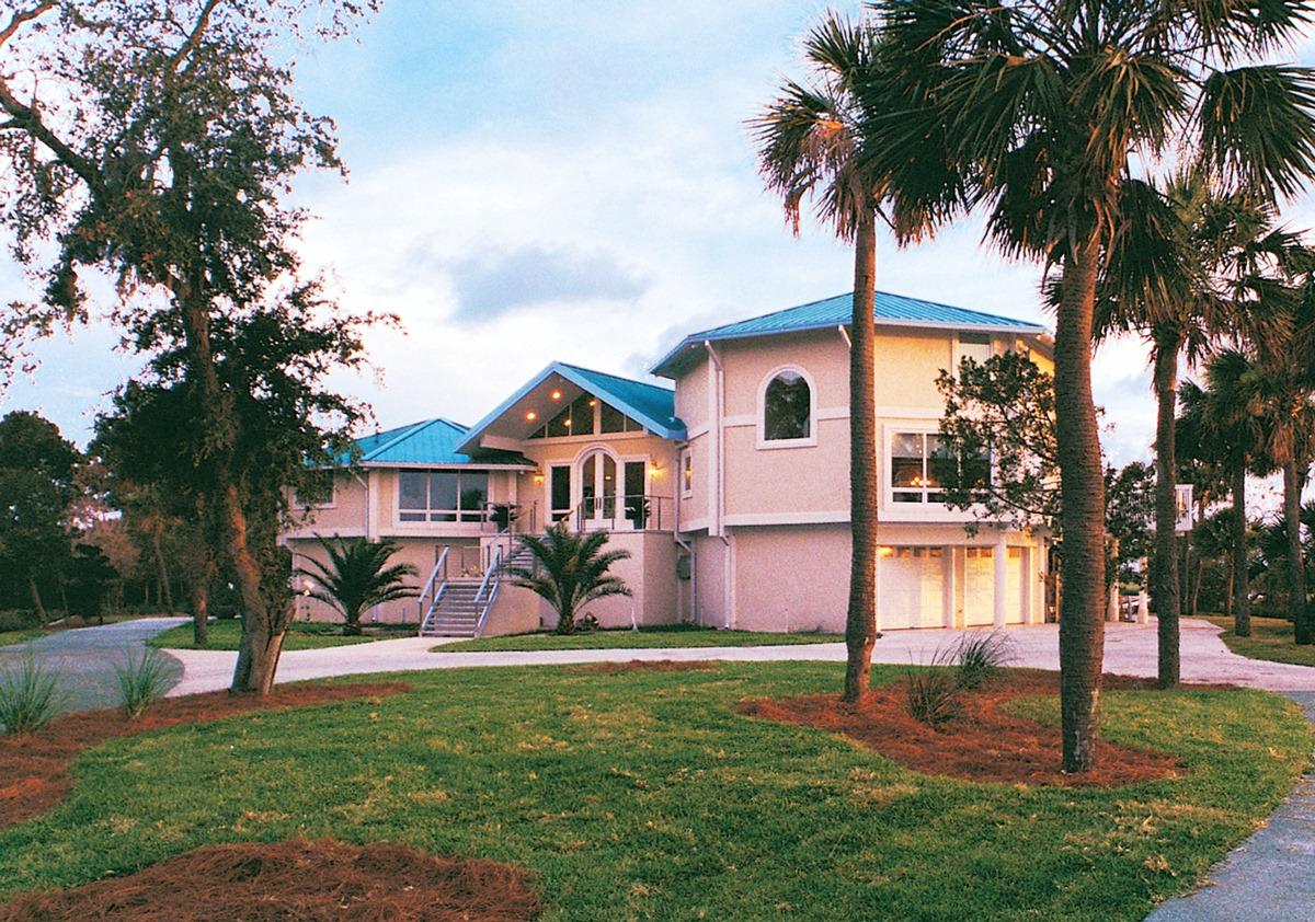 This coastal South Carolina hurricane-resistant home was built on concrete piers with the ground level area enclosed. 