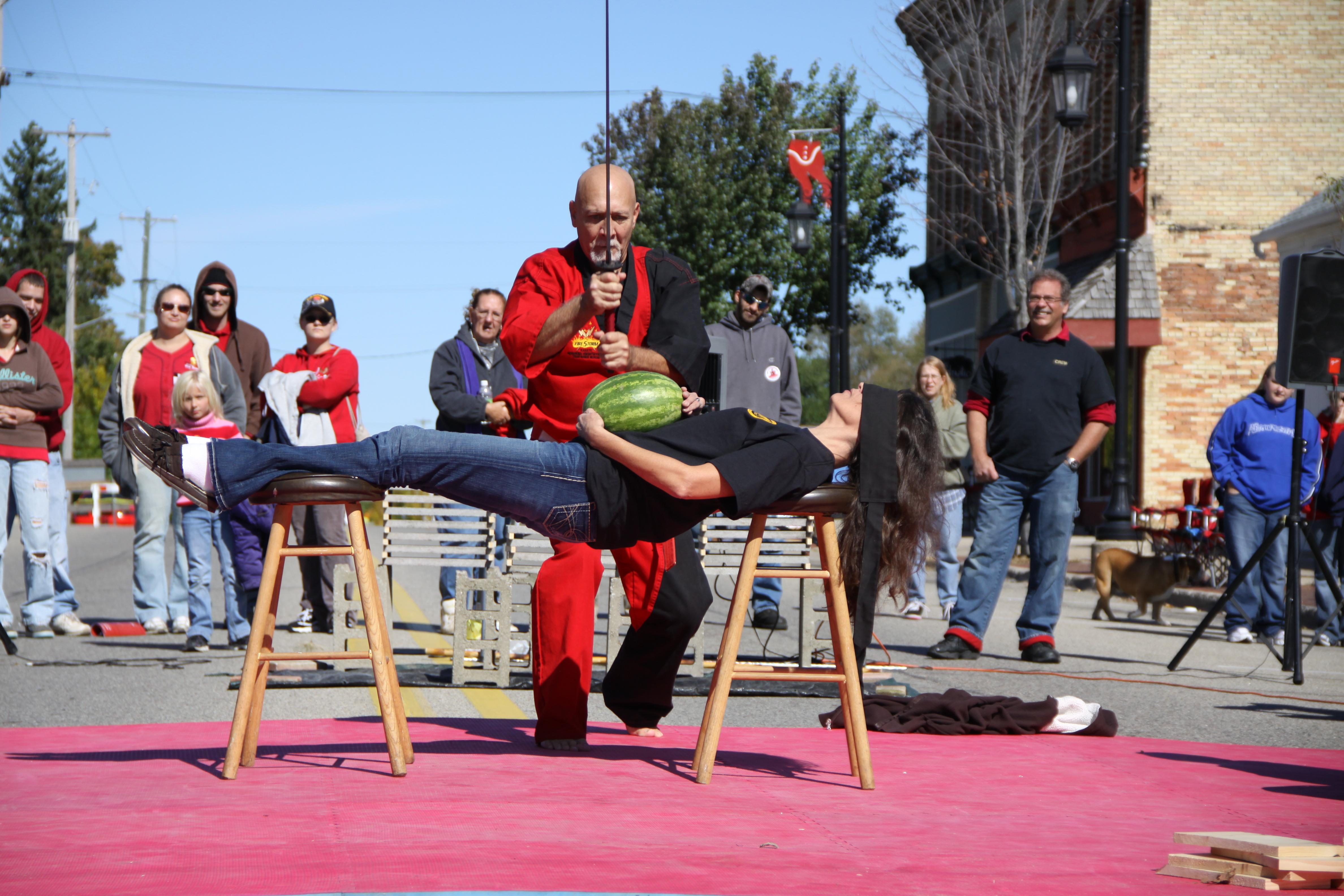 Kyoshi Gravelin cuts a watermelon off the belly of his beautiful assistant Arleen...This trusting woman believes in Kyoshi's incredible sword skills... 2...