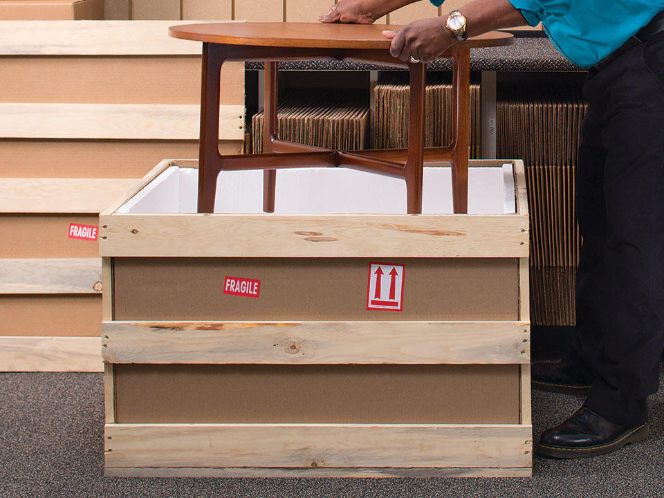 Associate freight packing an antique table