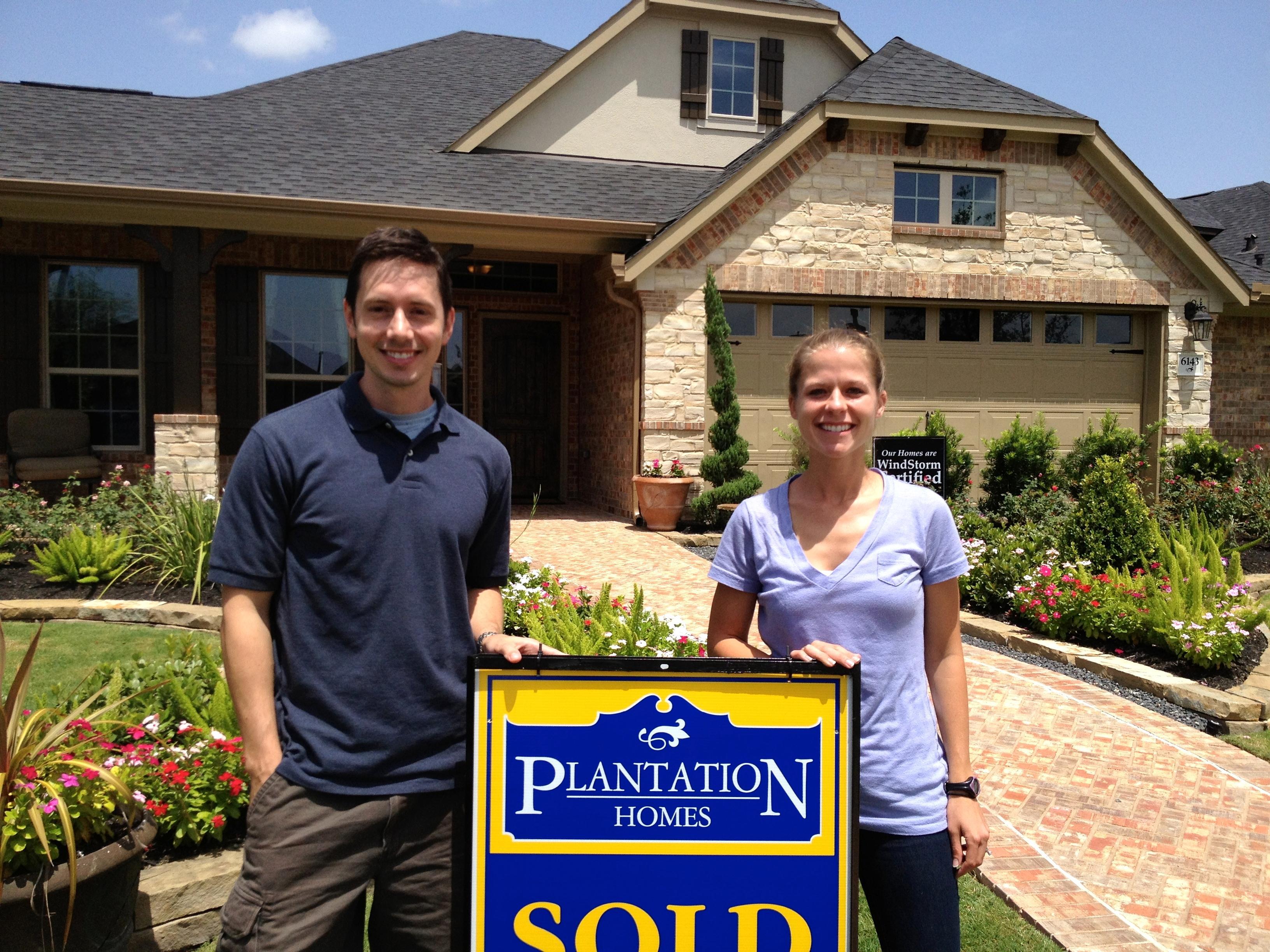 Scott and Elizabeth in front of their new home!