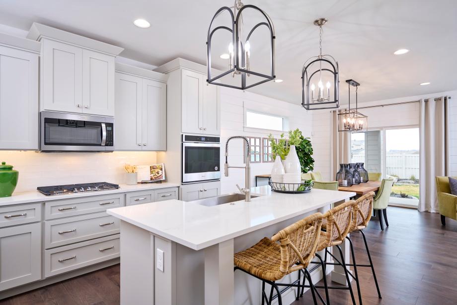 Crisp white kitchen with statement piece pendant lights