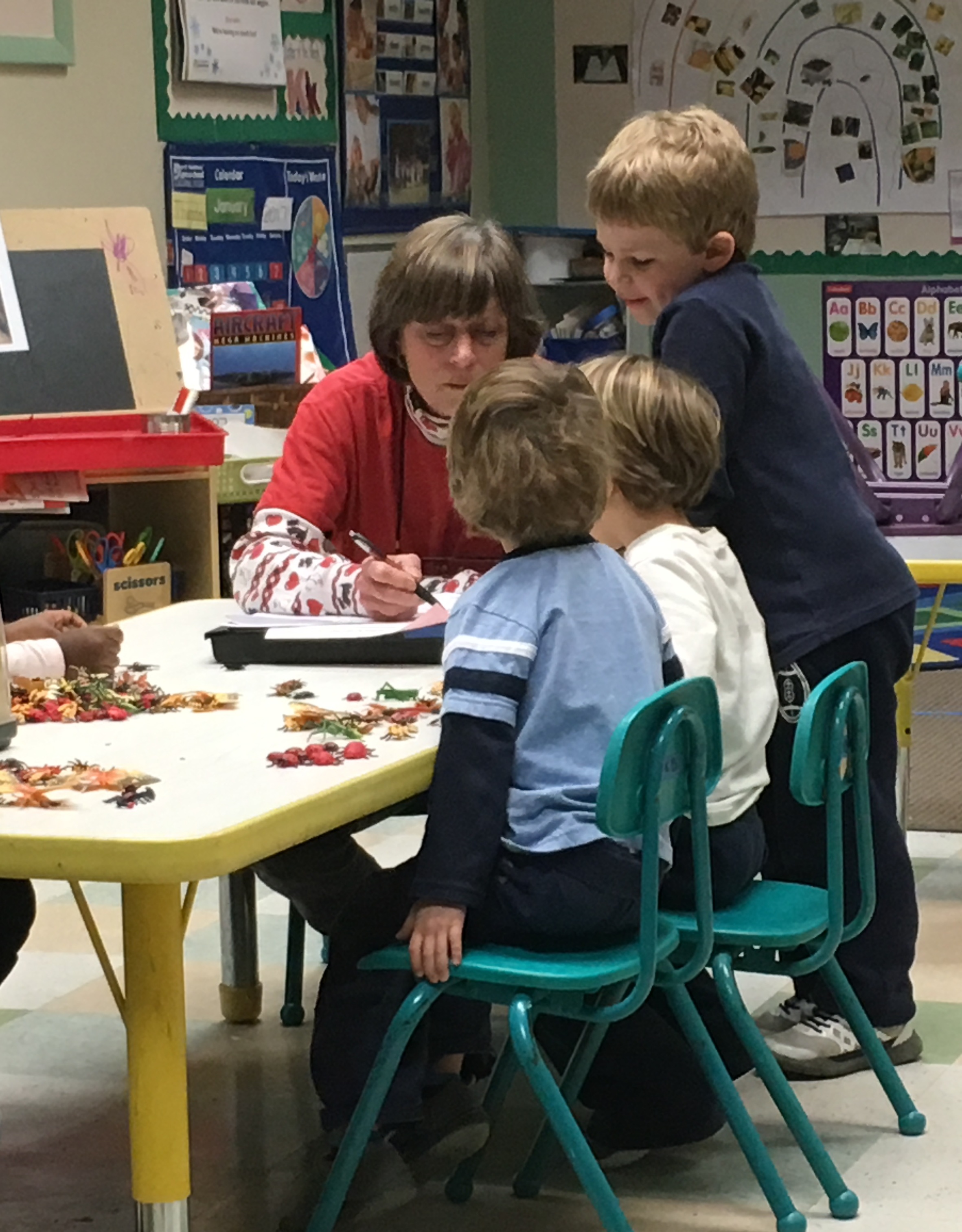Our Prekindergarten Classroom B friends are enjoying a math activity with Ms. Debbie.