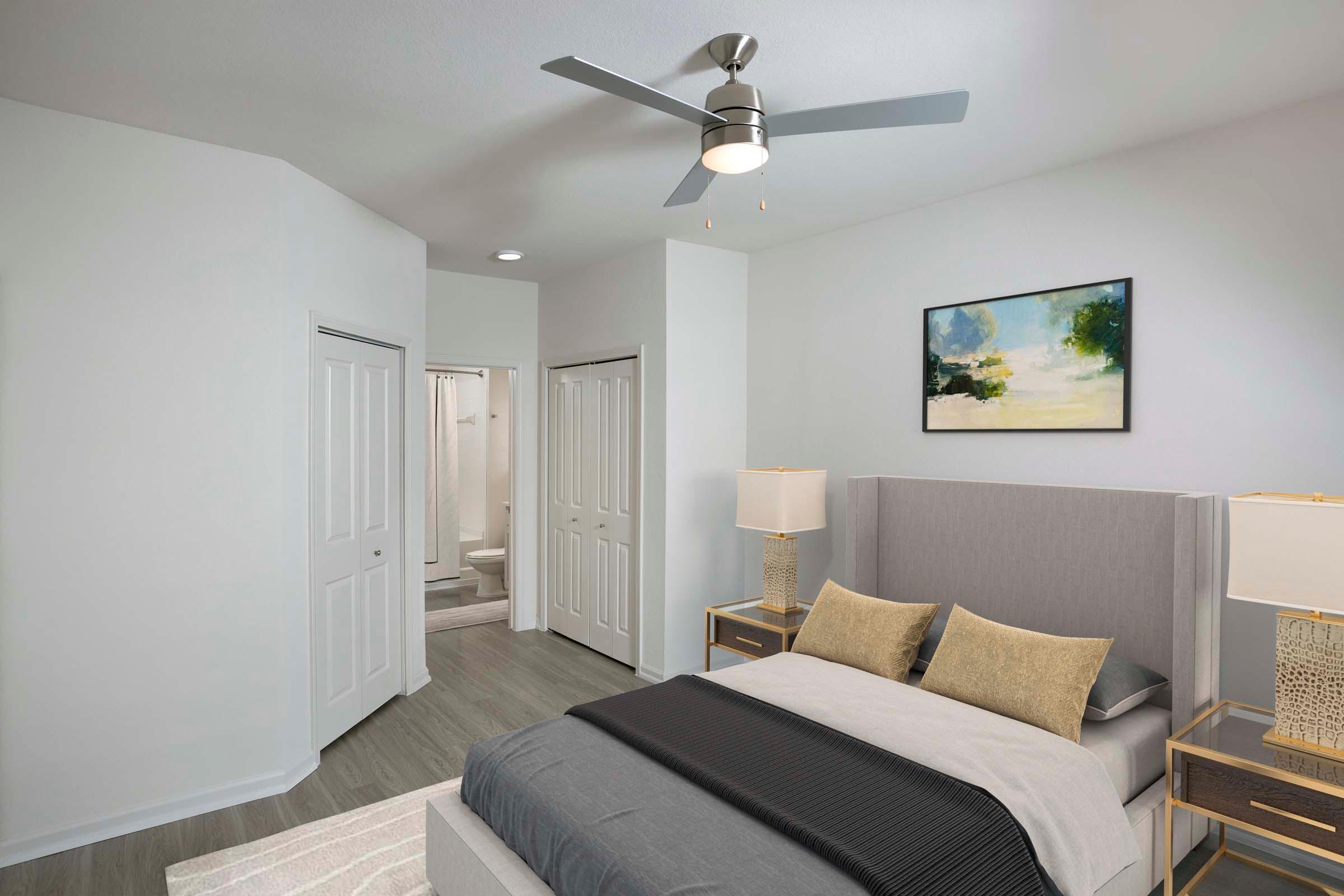 Bedroom with lighted ceiling fan and ensuite