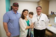 Dr. Richard Hertle with a patient family. Dr. Richard Hertle with a patient family.