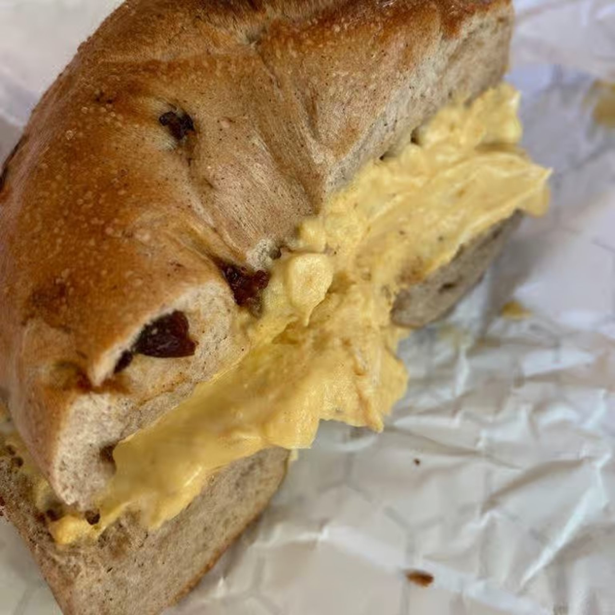 A bagel with cinnamon raisin spread