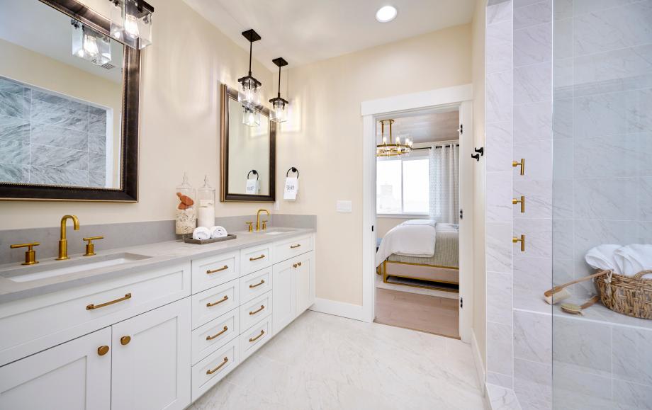 Restful primary suite with full tile shower and dual sink vanity