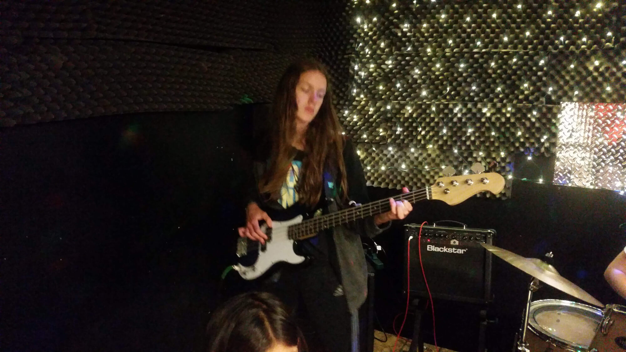 One of our students rehearses her bass part.