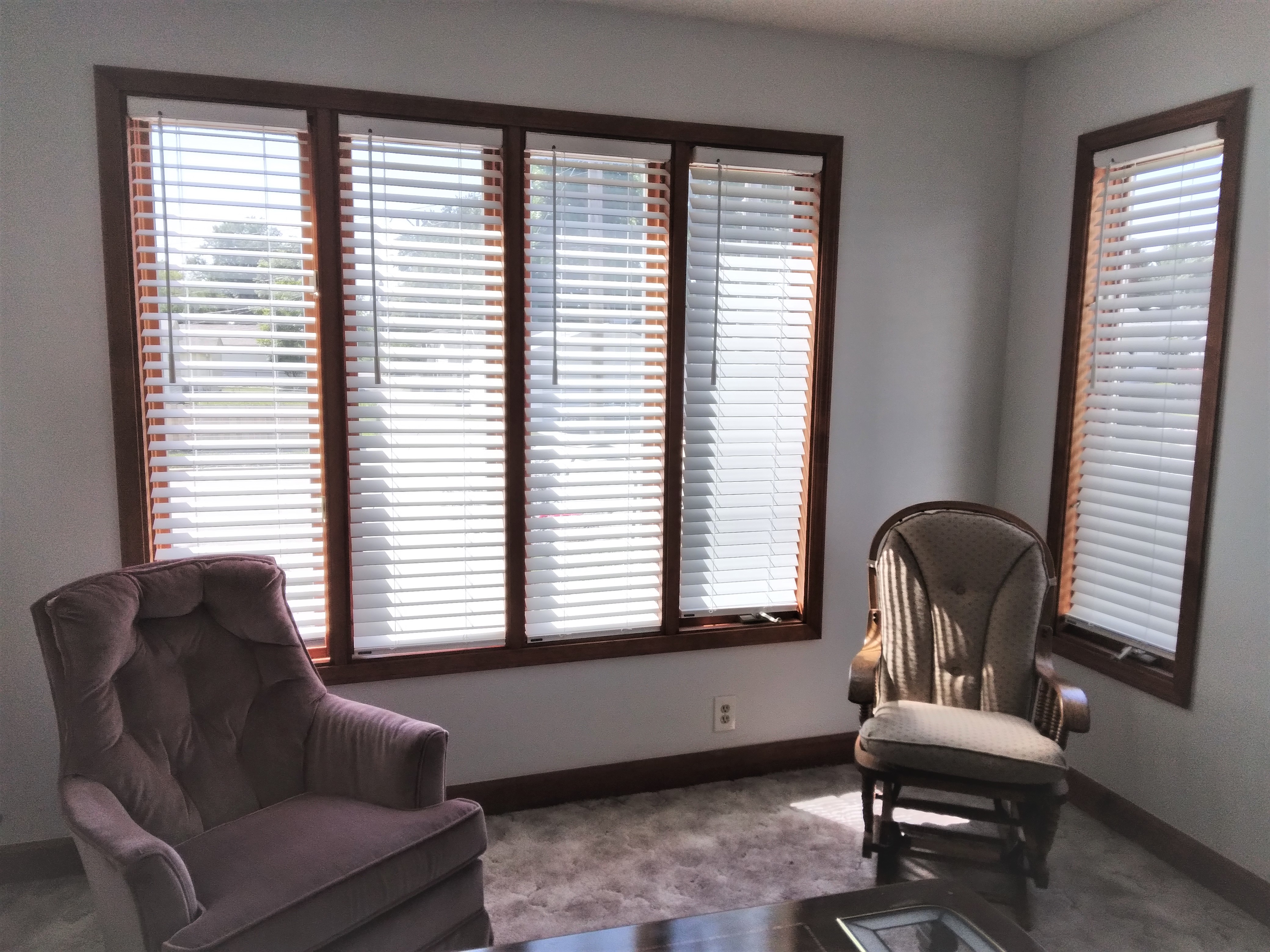 White cordless faux-wood blinds in Springfield Illinois living room.  BudgetBlinds  WindowCoverings  Blinds  SpringfieldIllinois