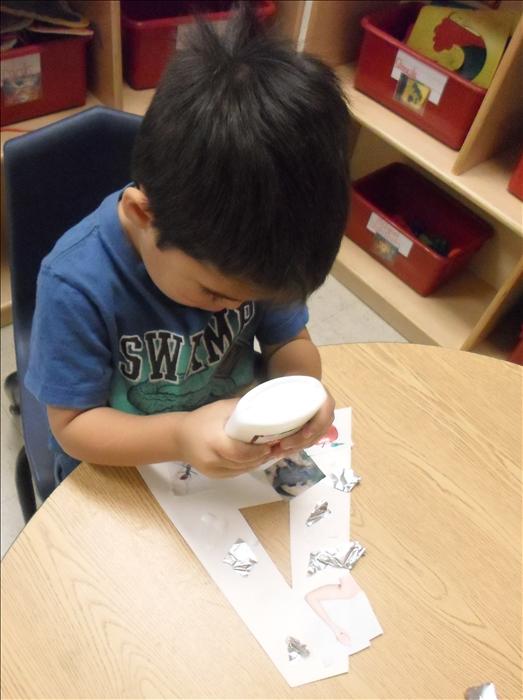 This is What Learning Looks Like: Nurturing creativity and letter recognition as they create works of art with collage letter.