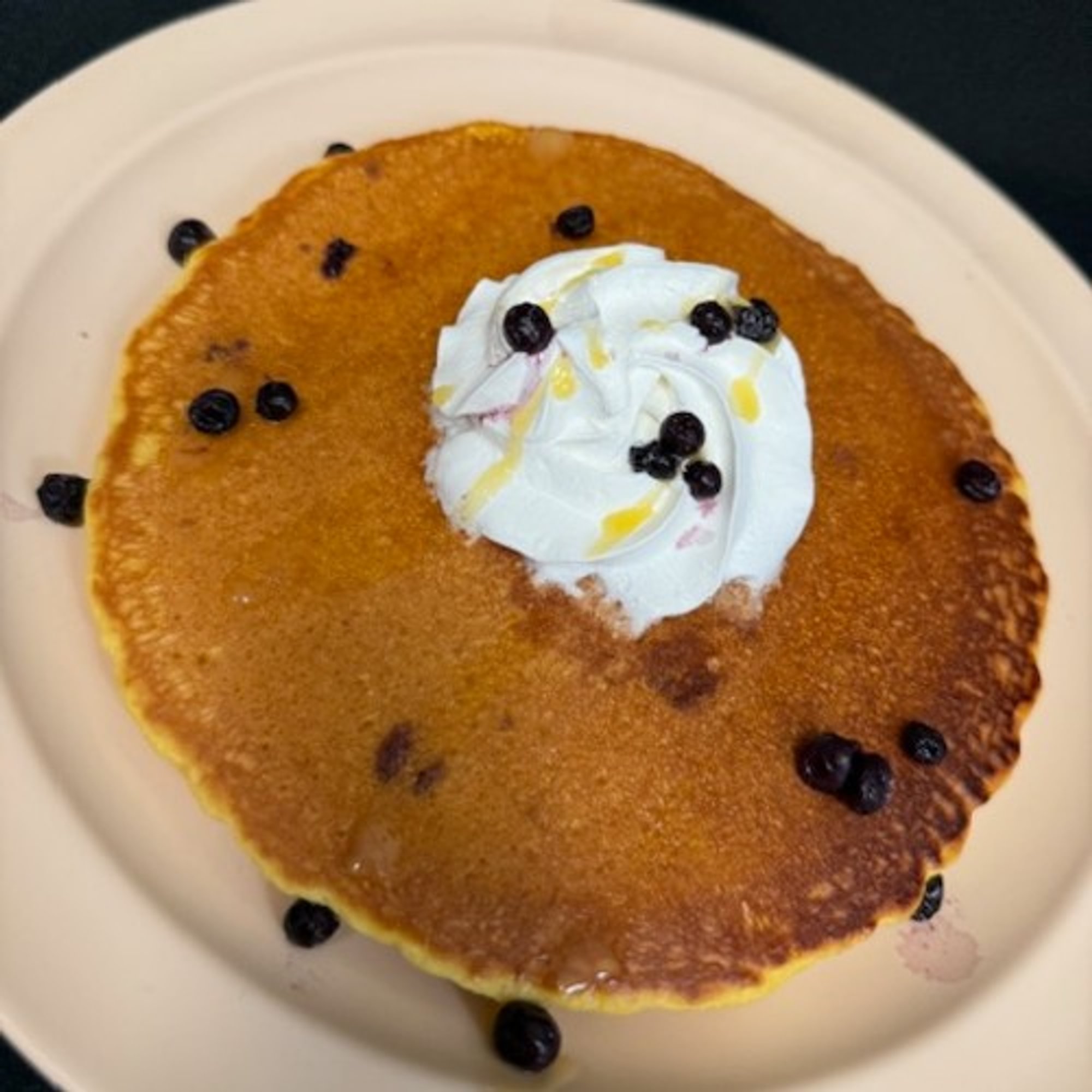 Two Hot Cakes with Blueberries and Whipped Cream