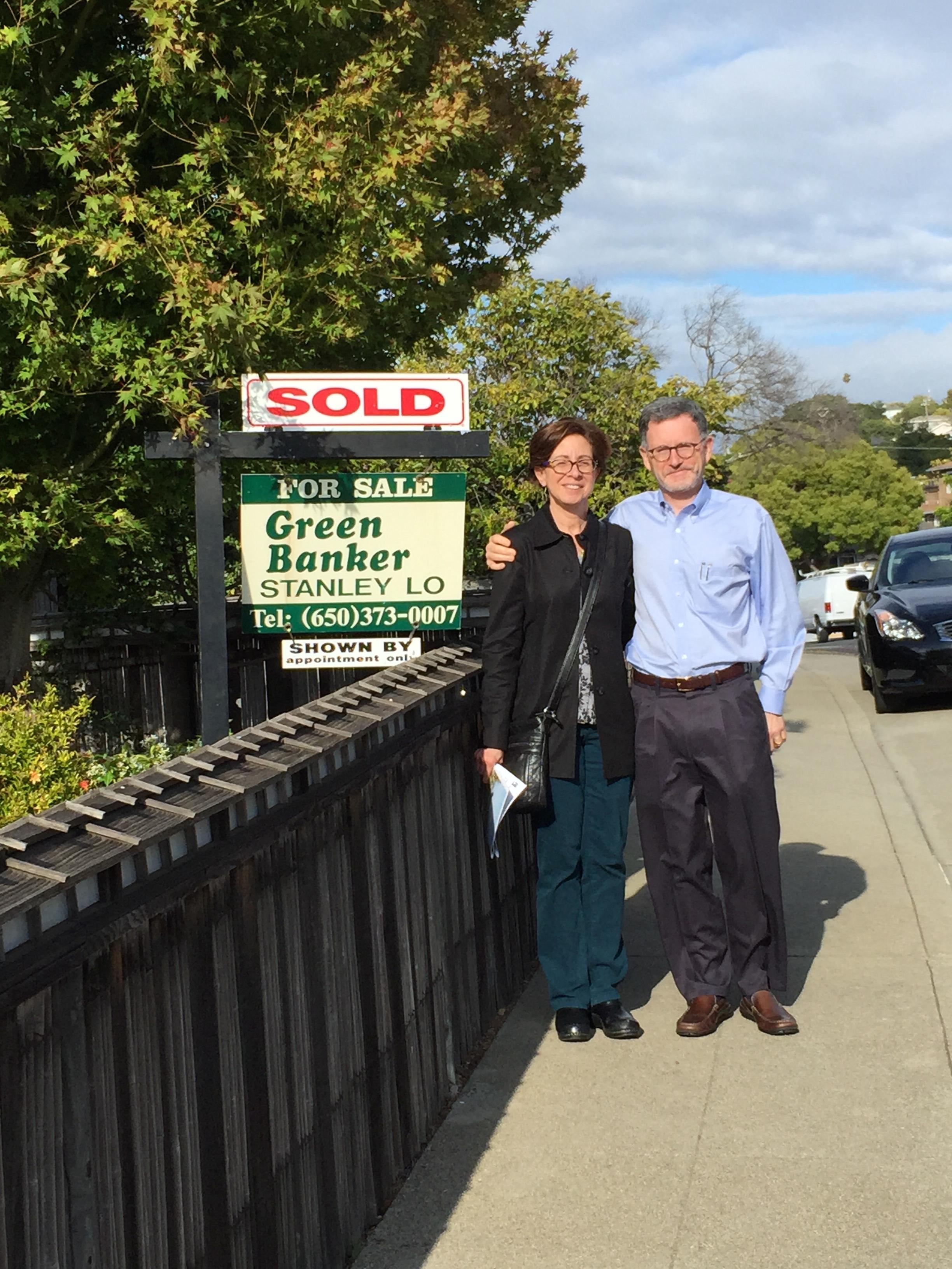 Very happy clients in front of their new home. 