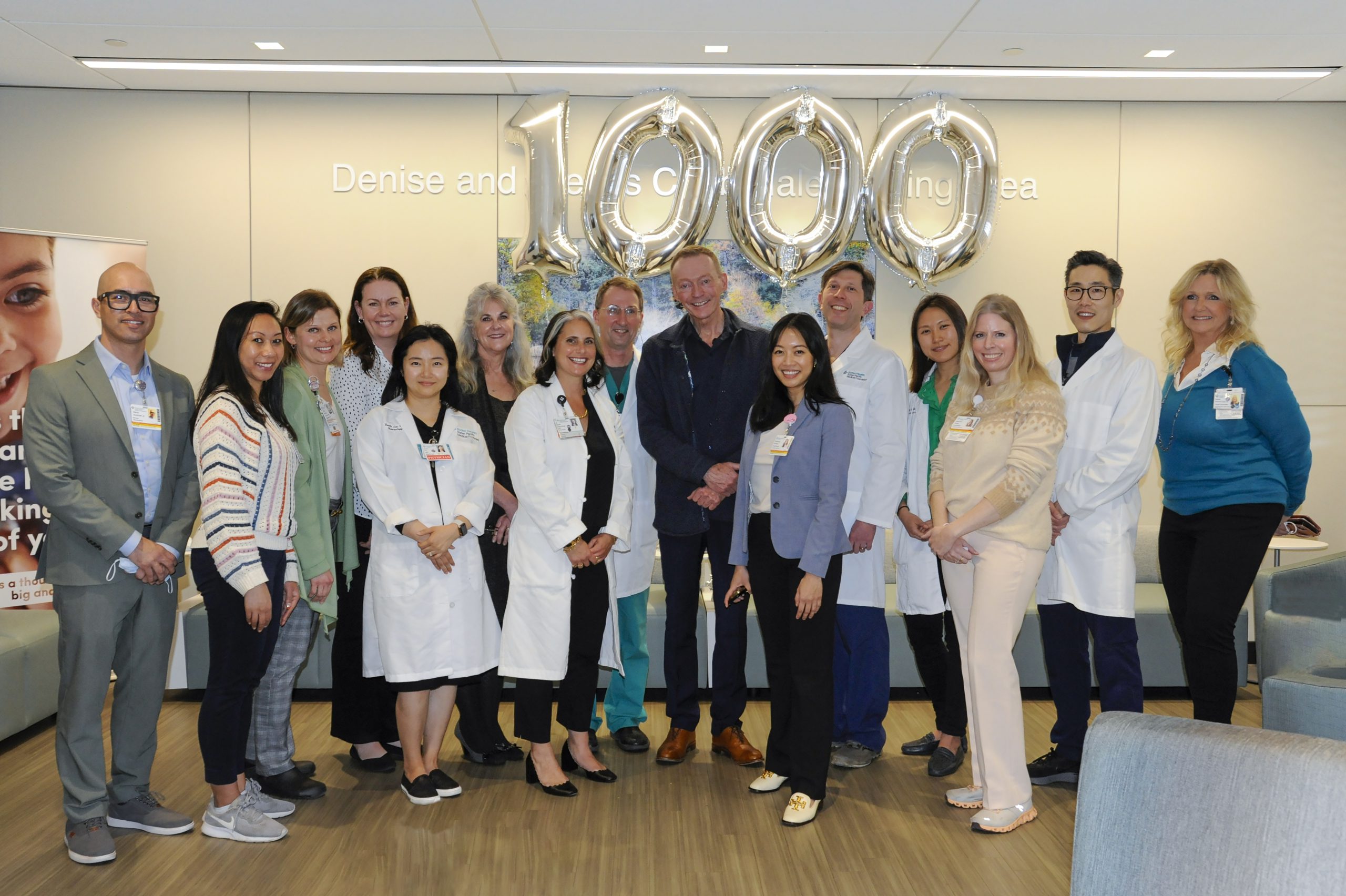 Sutter patient Martin Hyland, an older Caucasian male, stands with more than a dozen men and women medical staff at CPMC in San Francisco.