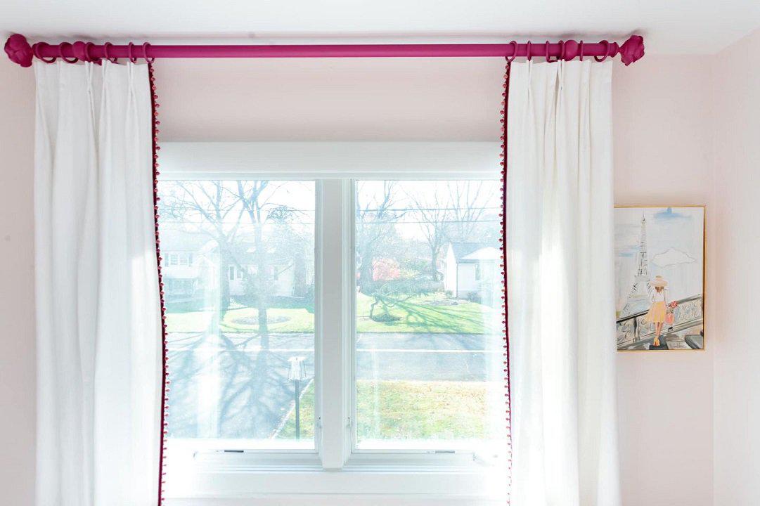 Fushia hardware and white drapes with pink pom poms...what's not to love for this little girls room.
