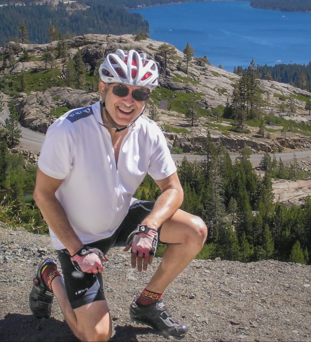 Man with bike helmet kneeling