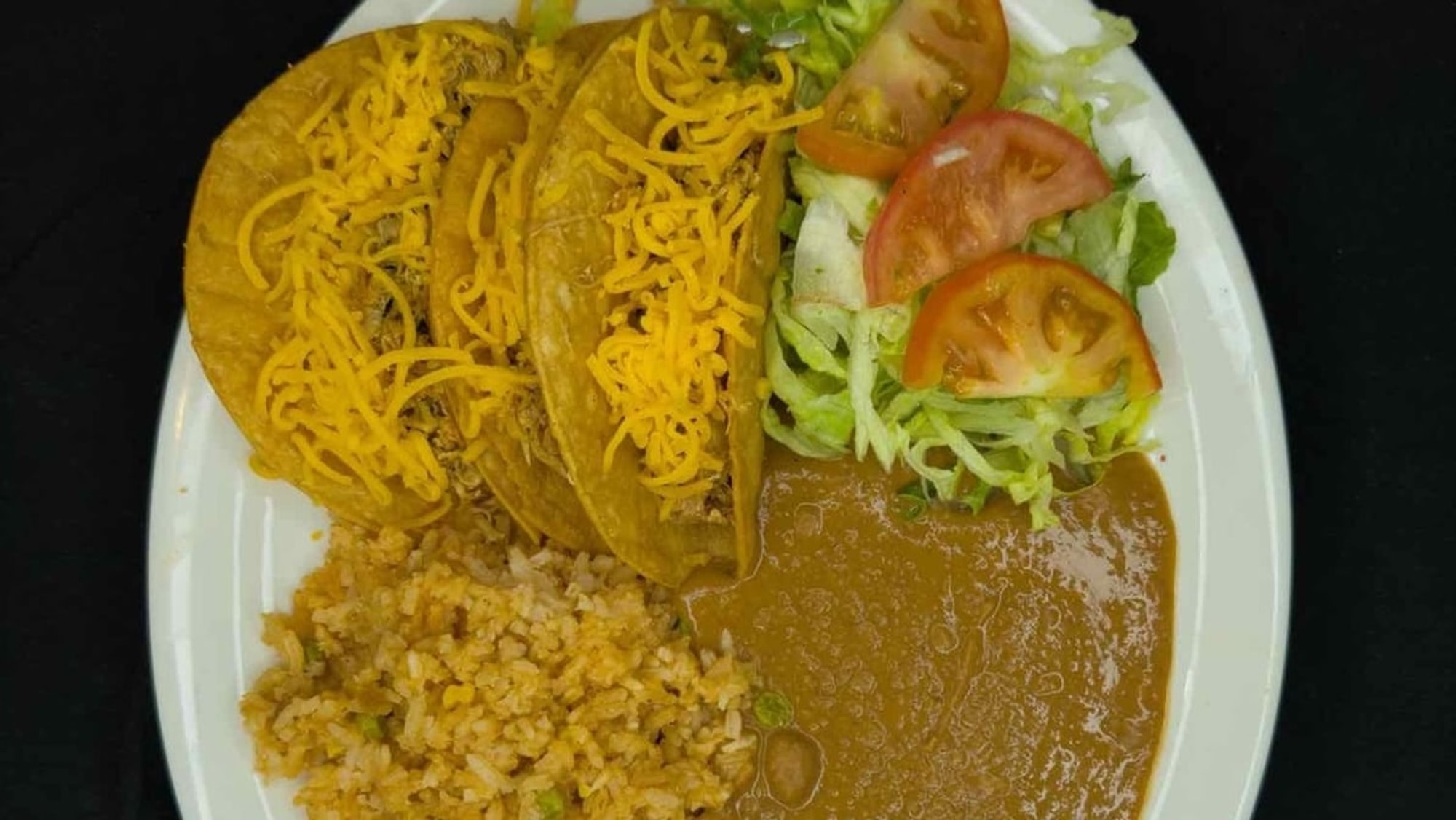 35. 3 Crispy Beef Tacos, Spanish Rice, Refried Beans, and Salad