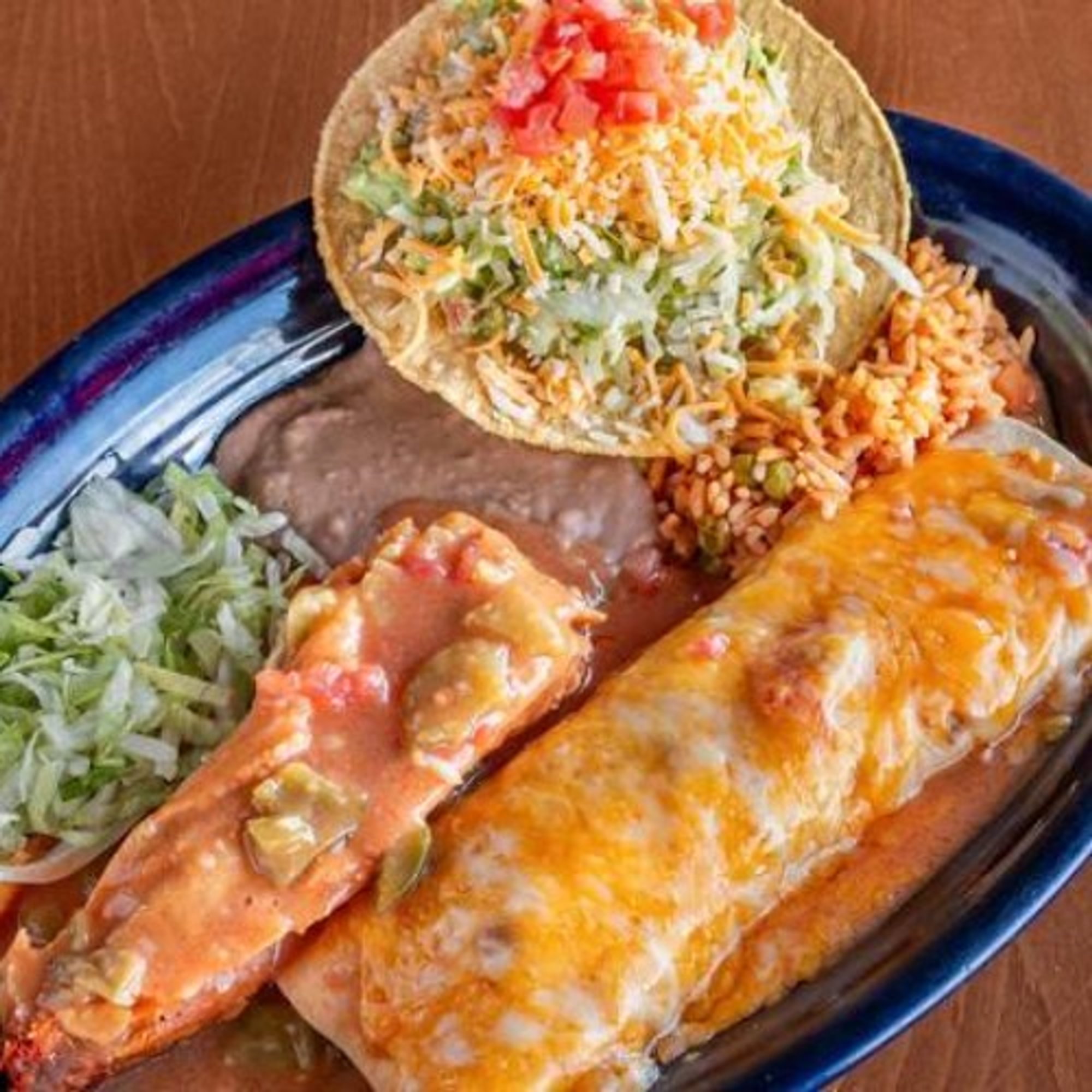 #7 Chicharrón Burrito, Tamale, Tostada, Beans and Rice
