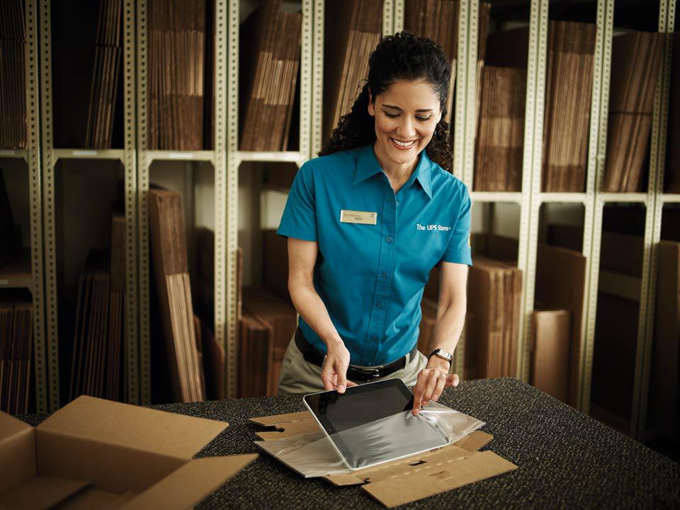 The UPS Store associate packing a laptop