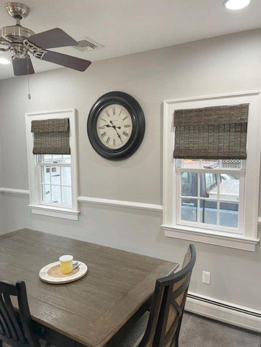 We love the contrast of these dark grey woven woods for this dining area! Call us for all your custom window treatments 201-387-0050.