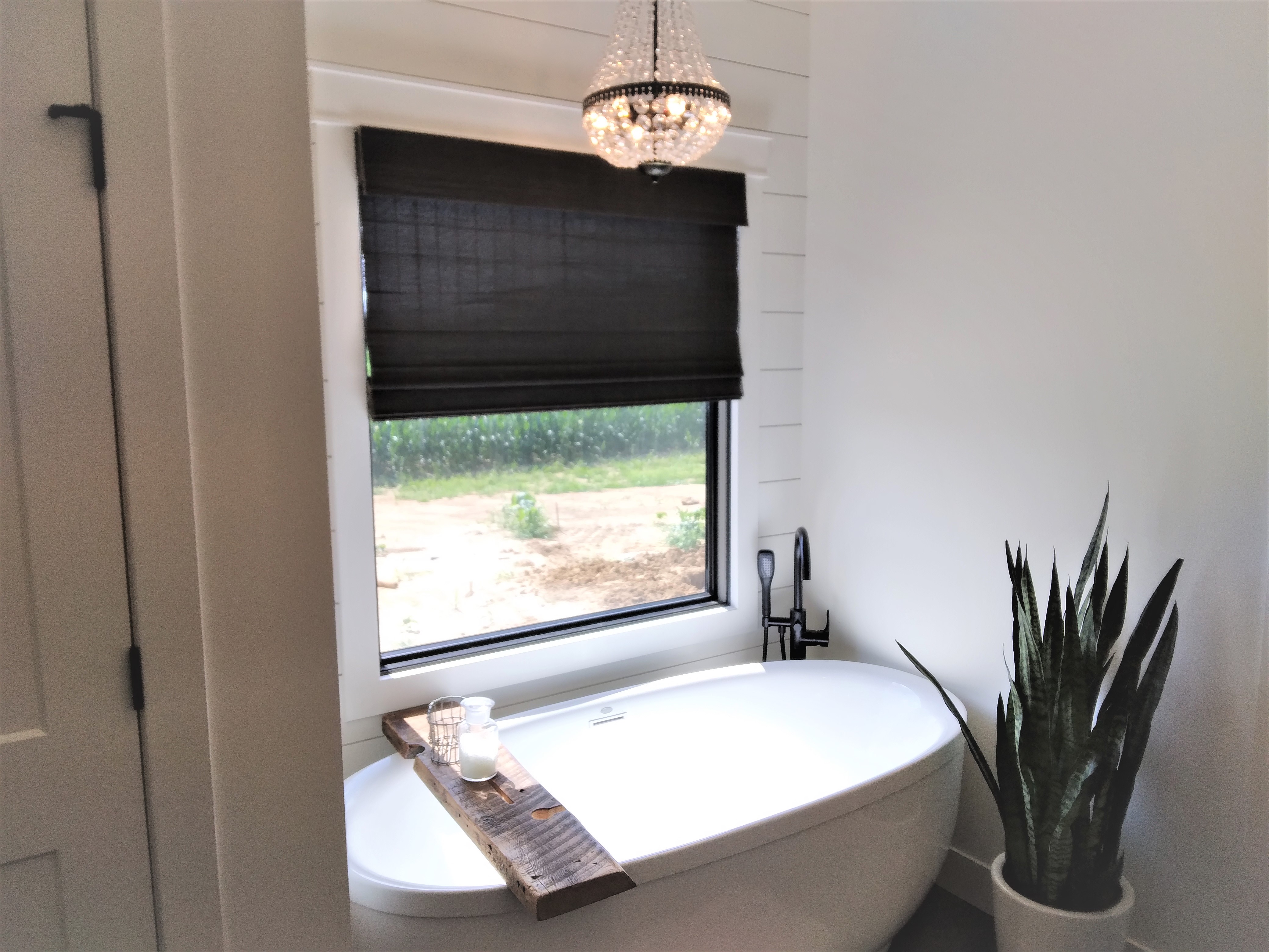 Black cordless light-filtering natural shades in Springfield Illinois bathroom.  BudgetBlinds  WindowCoverings  NaturalShades  SpringfieldIllinois