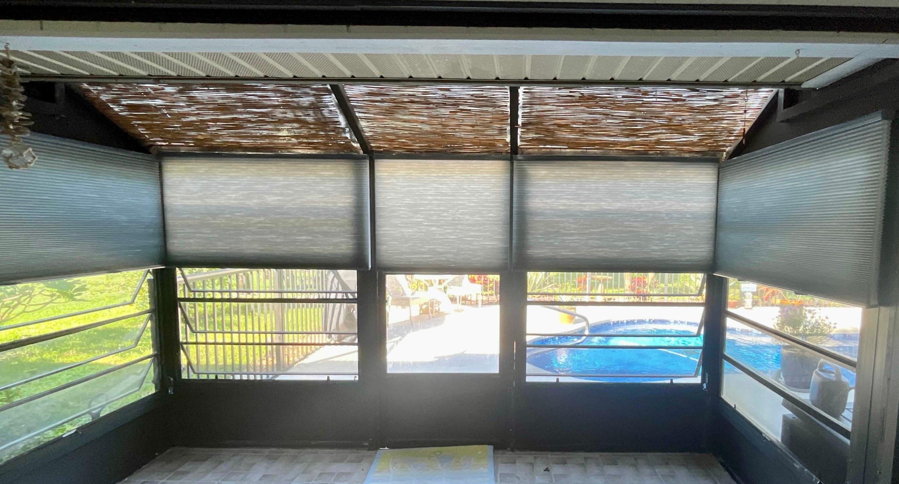 Our dual top-down/bottom-up cellular shades offer maximum versatility, making them a popular option for privacy and lighting control. This Vero Beach sunroom is the perfect example of how these shades are both attractive and functional!