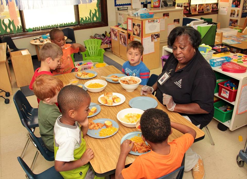 Here at KinderCare we participate and encourage Family-Style dining where the children learn to serve, share and prepare meals together.