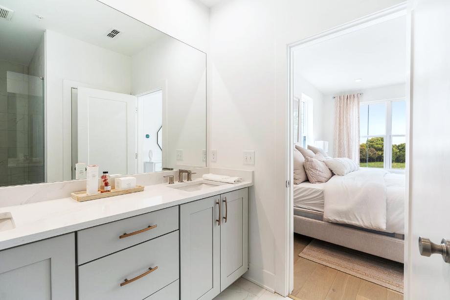 Spa-like primary bathroom includes a large luxe shower with seat, and private water closet