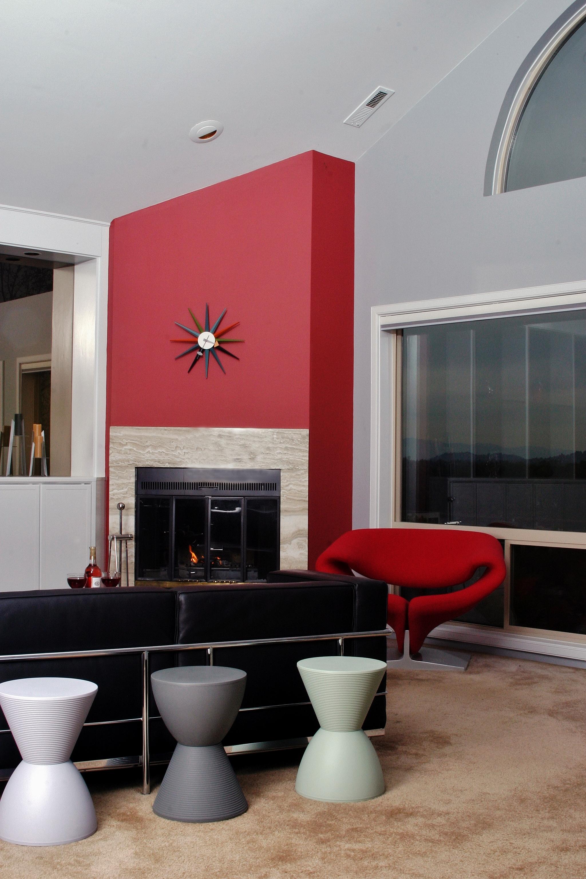 For a fresh take on modern style, my customer and I planned this room around the red diagonal wall surrounding the fireplace. All the furnishings popped in black, white or red.