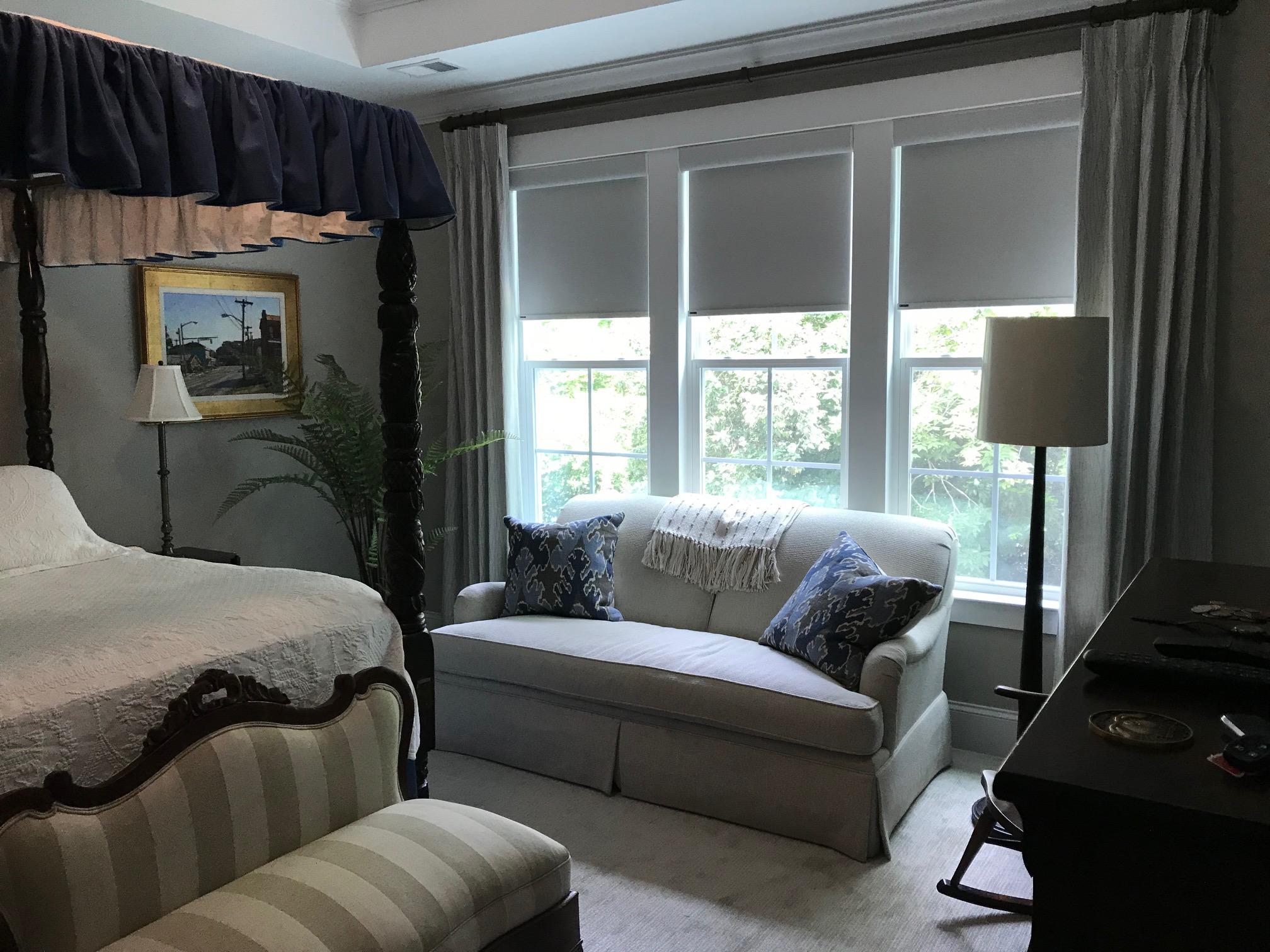 Room Darkening Roller Shades and Draperies really transformed this beautiful Master Bedroom