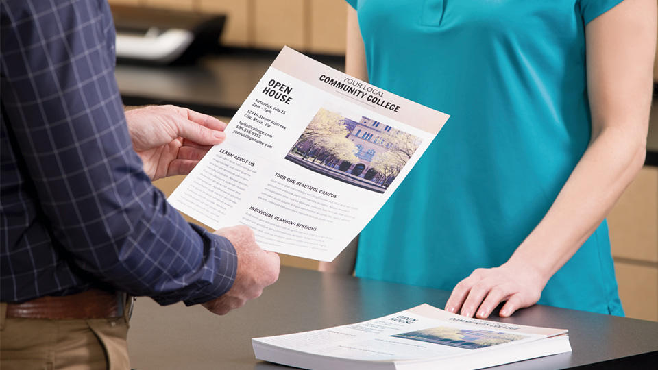 customer holding printed flyer