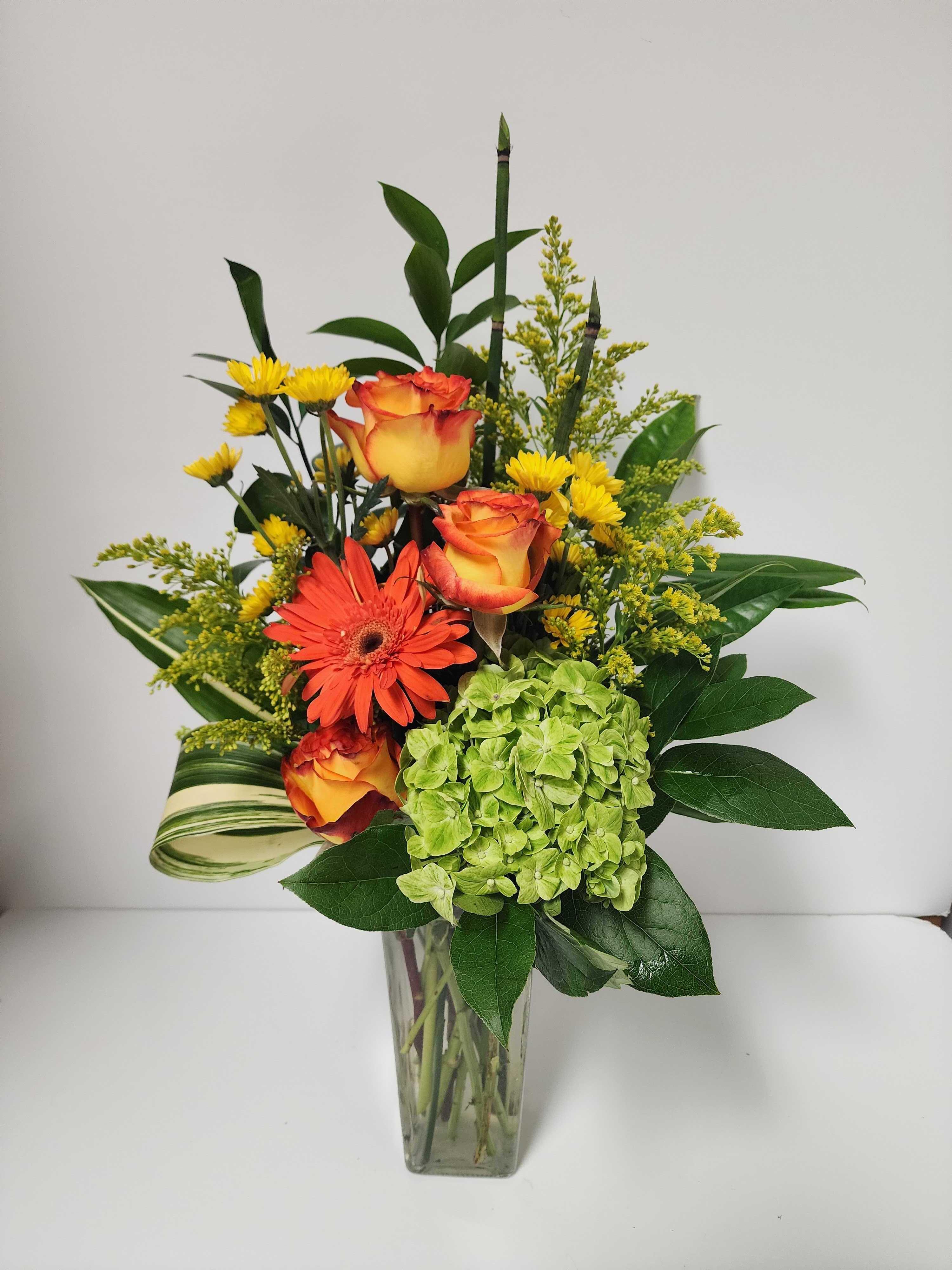 Orange Daisy and rose with green hydrangea arrangement by Country Greenery at The Galleria
