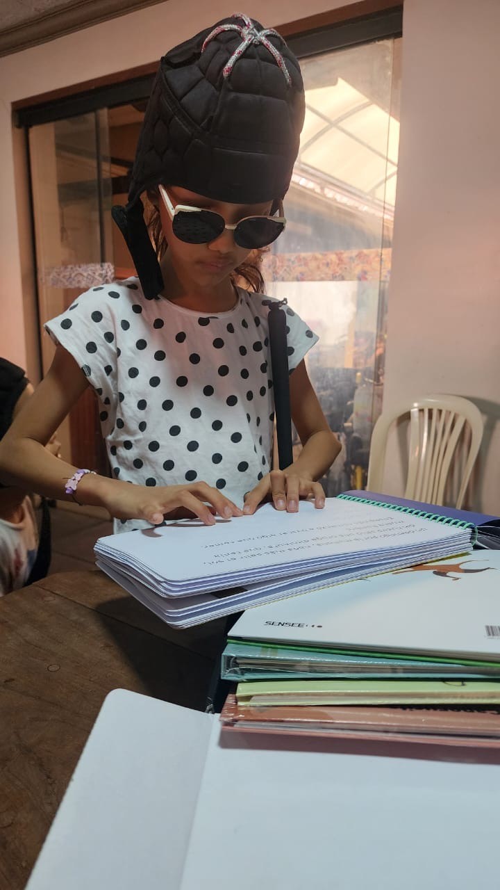 A young girl reads a book