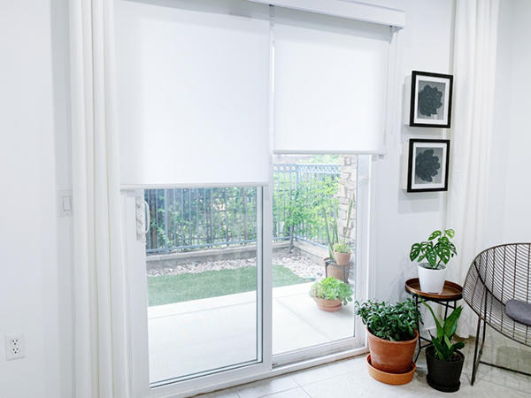 Roller Shades on a sliding glass door with white drapery panels in Old Town.