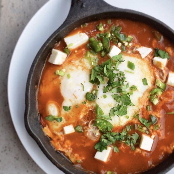 Shakshuka, 2 Eggs Poached in Tomato Sauce, Shredded PB cheese, Onions, Cilantro, Serrano Peppers...