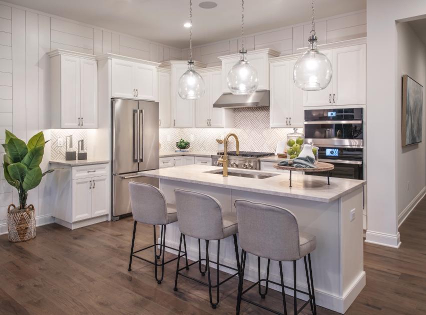 Gorgeous kitchens with large center islands, brand-named stainless steel appliances, and granite countertops