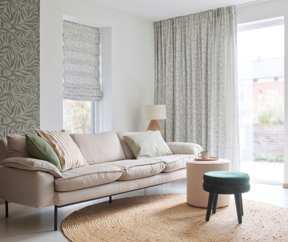 Custom drapery paired with custom roman shades is a stunning match in this cozy living room!