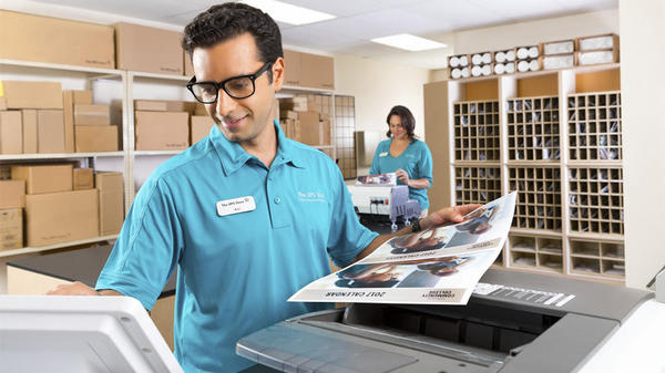 store associate creating copies at the ups store