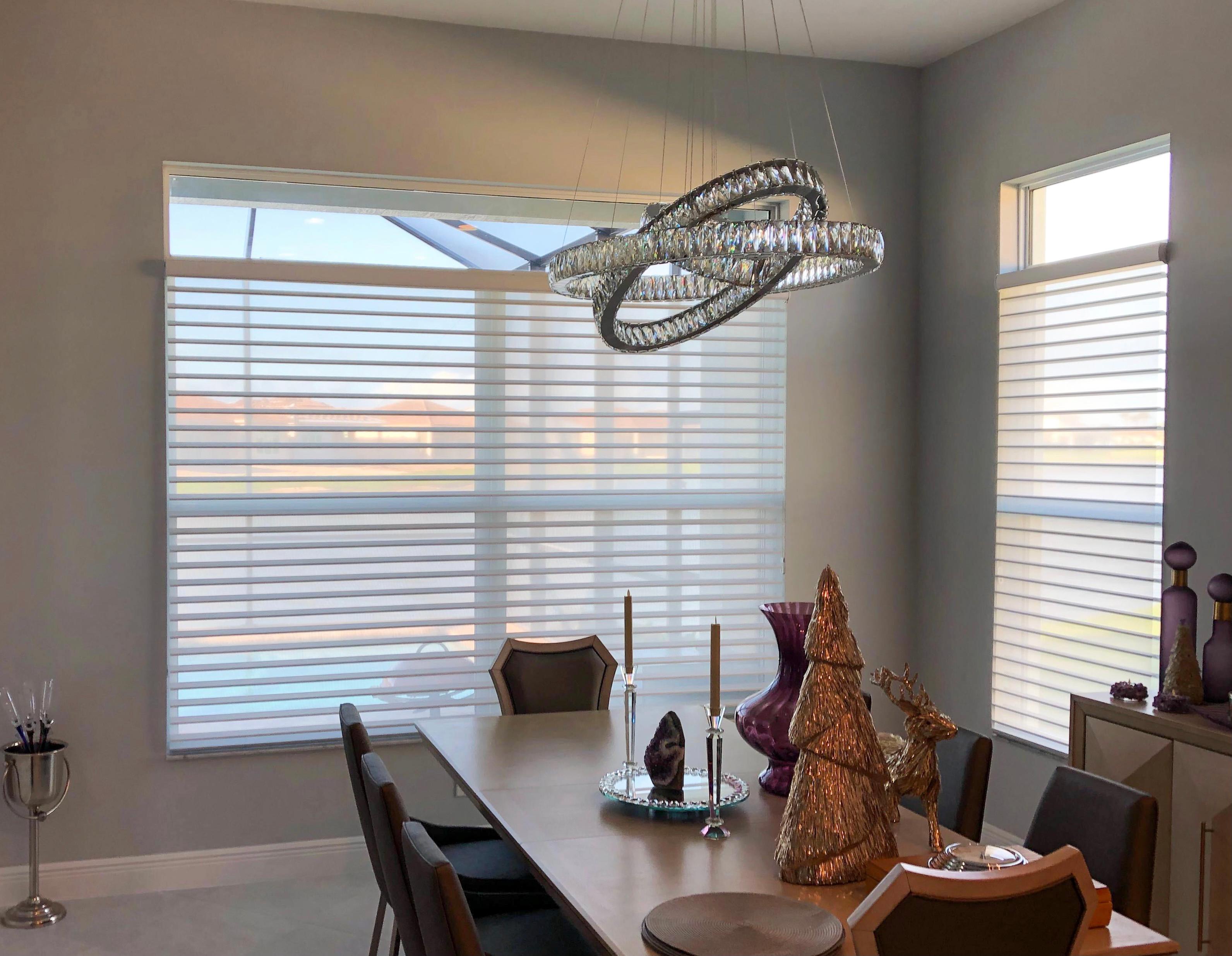 Simple white blinds frame this modern dining room in Vero Beach.