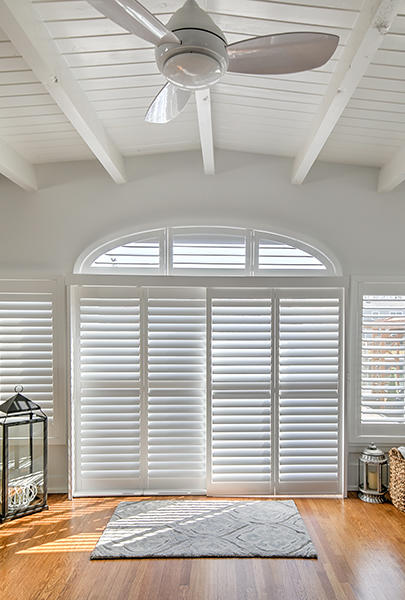 WOW!  White Custom By-Pass Shutters with functional Arched Shutters truly make a statement in this home in Bay Park!