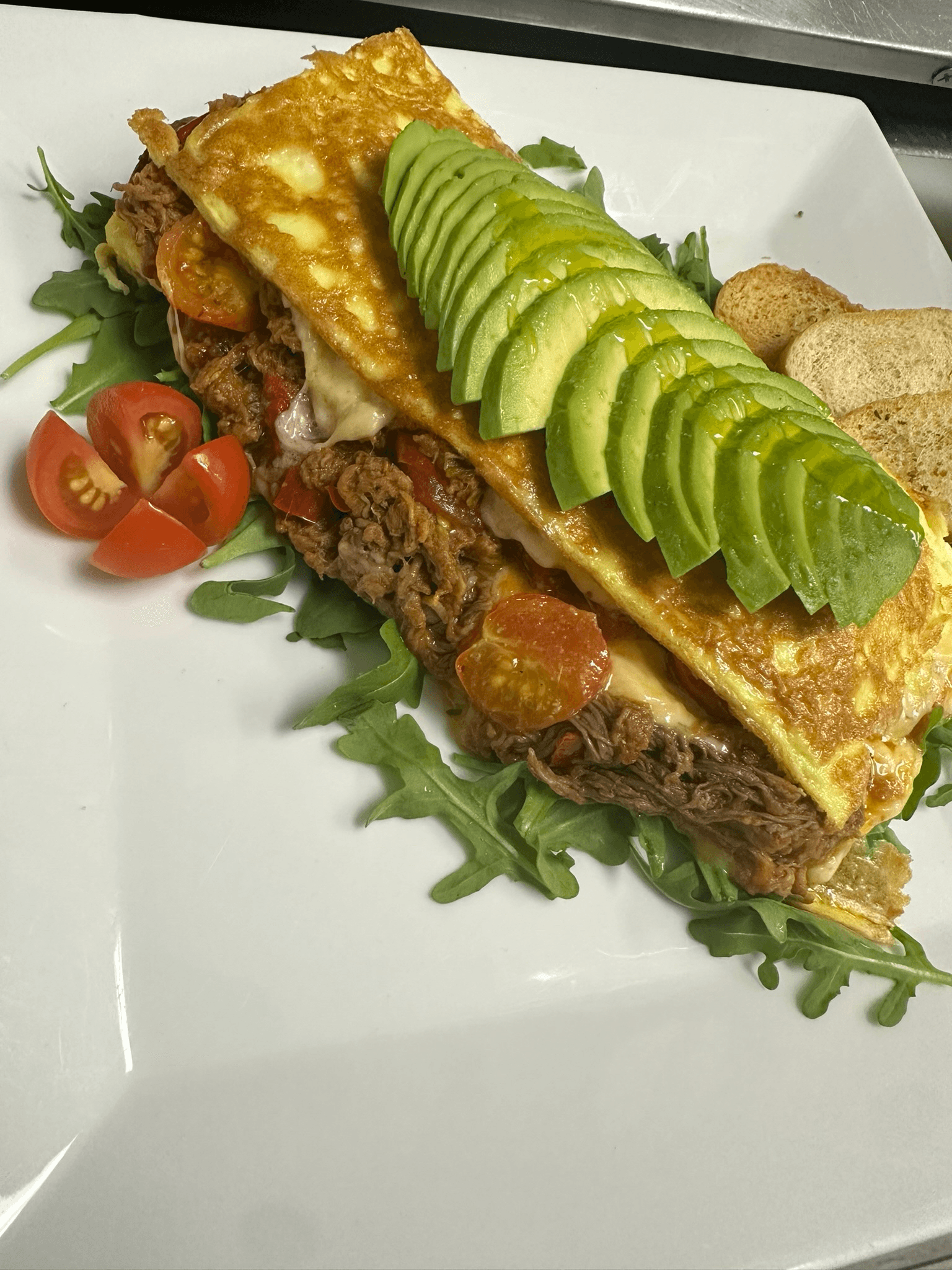 COWBOY OMELET (Shredded beef, red reppers, red onion, diced tomatoes, plantains, mozzarella)