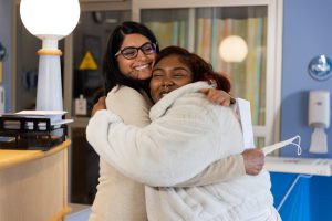 Dr. Shilpa Patil and Paris Sweeney Austin embrace.