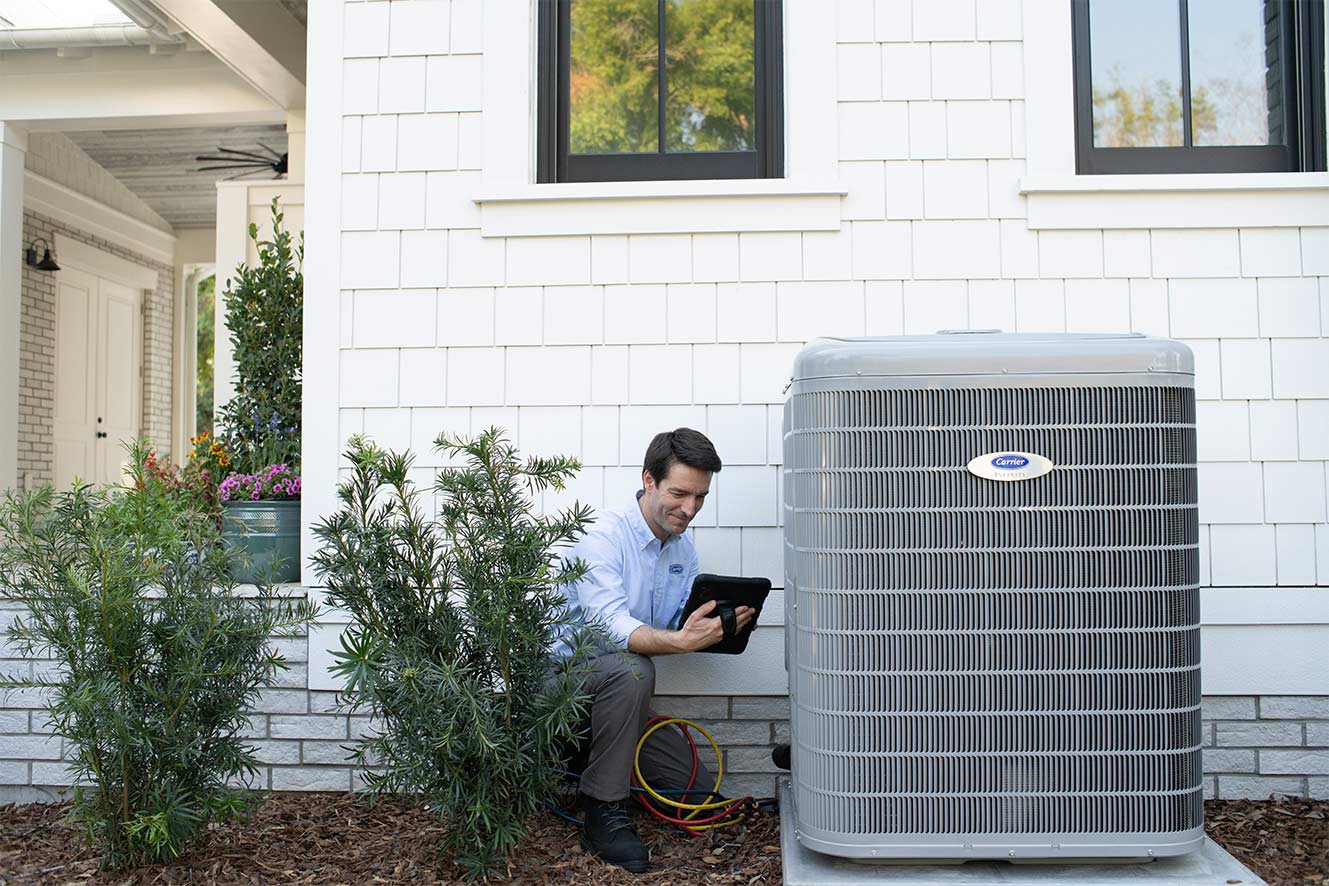 A Carrier dealer performs a heat pump repair.