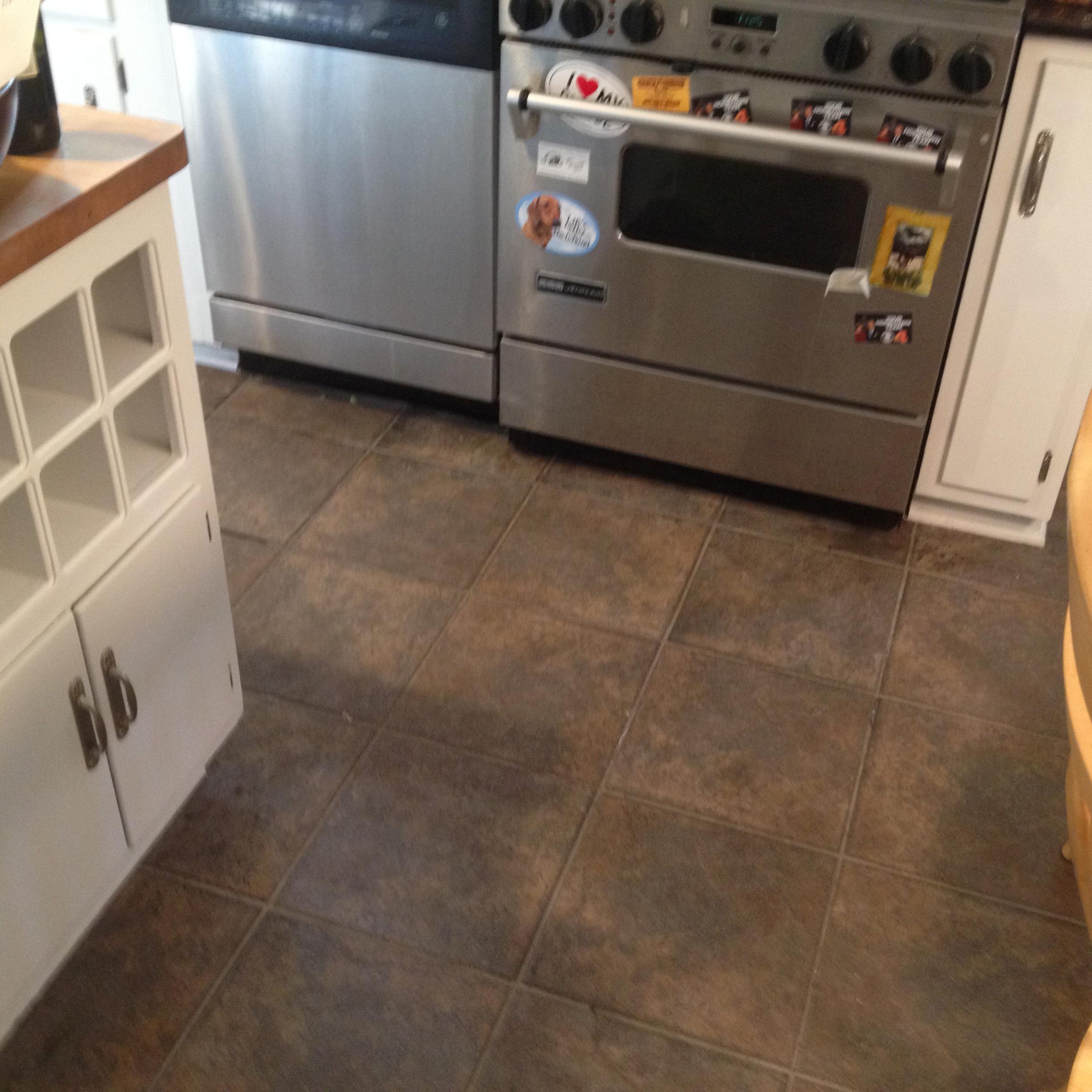 The  tile in this kitchen were cracked, dark and gave the kitchen a unpleasant  design