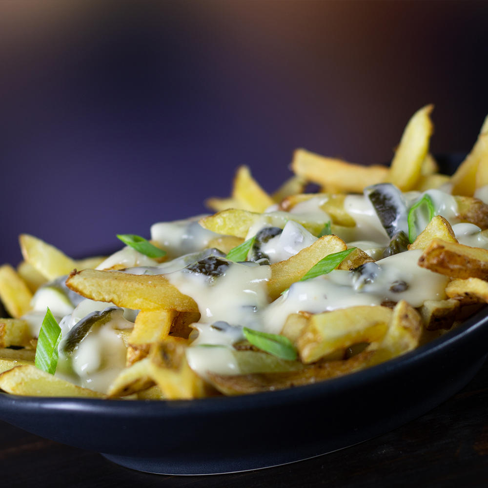 Our Smoked Gouda Cheese Fries with Roasted Poblano Chiles and Scallions