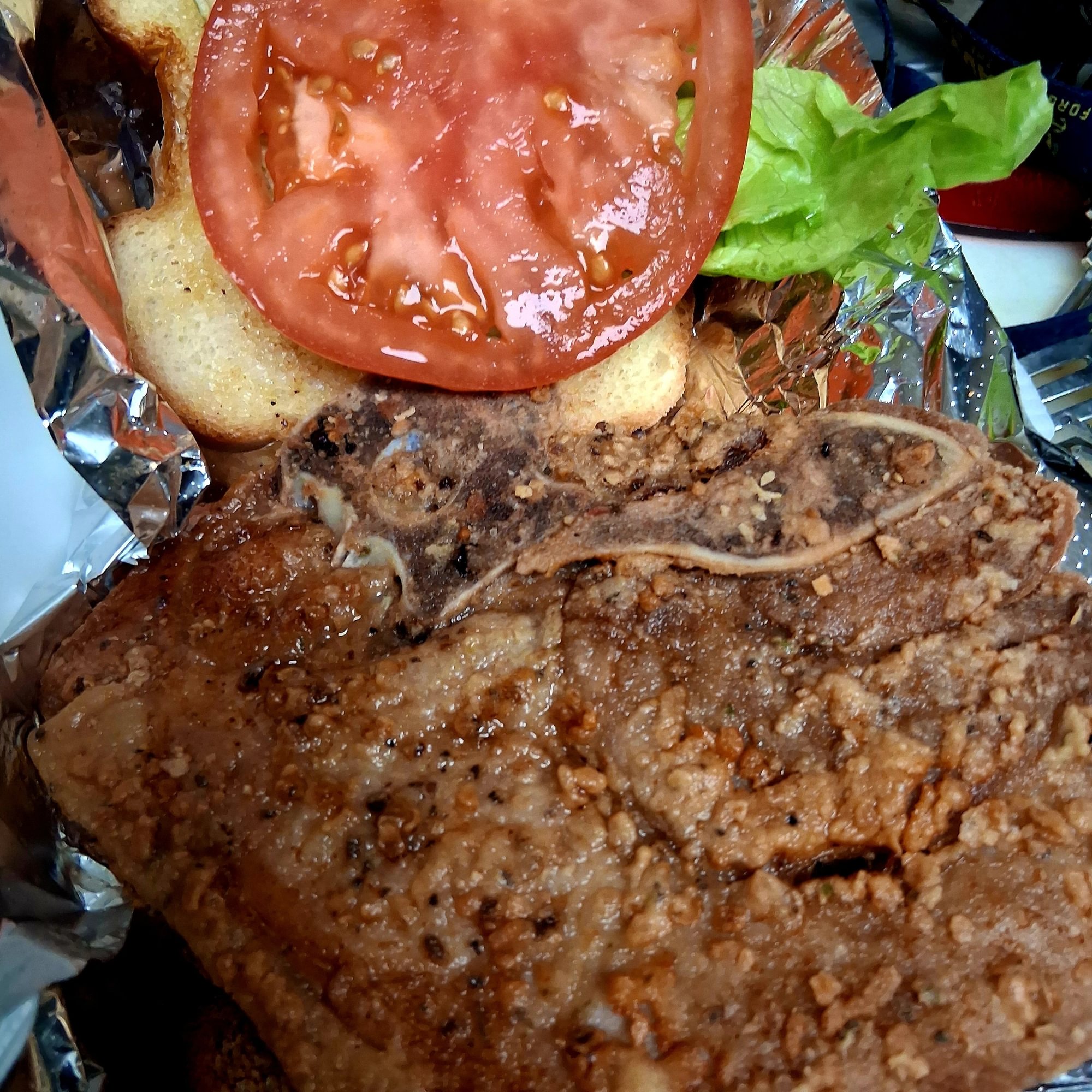 Pork chops sandwich with mayo, lettuce, tomato
