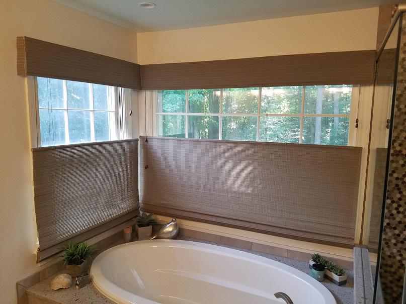 Turn your bathroom into a sanctuary! These gorgeous Top-Down, Bottom-Up Bamboo Shades by Budget Blinds of Arlington & Alexandria add an earthy feel to the room and make a soothing bath even more serene.