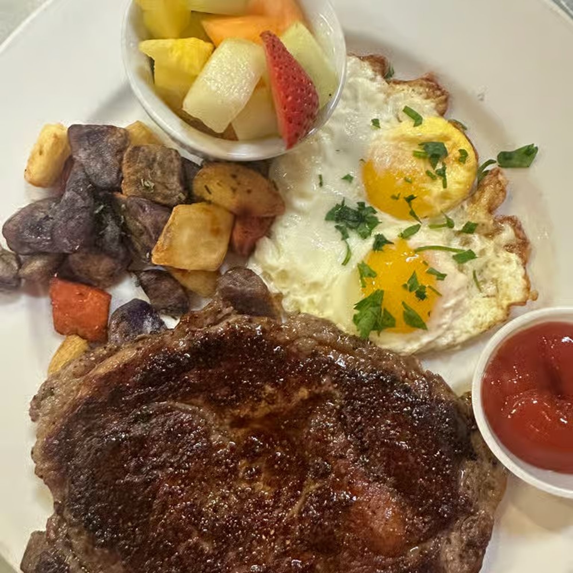 Grilled angus certified rib eye steak and eggs brunch