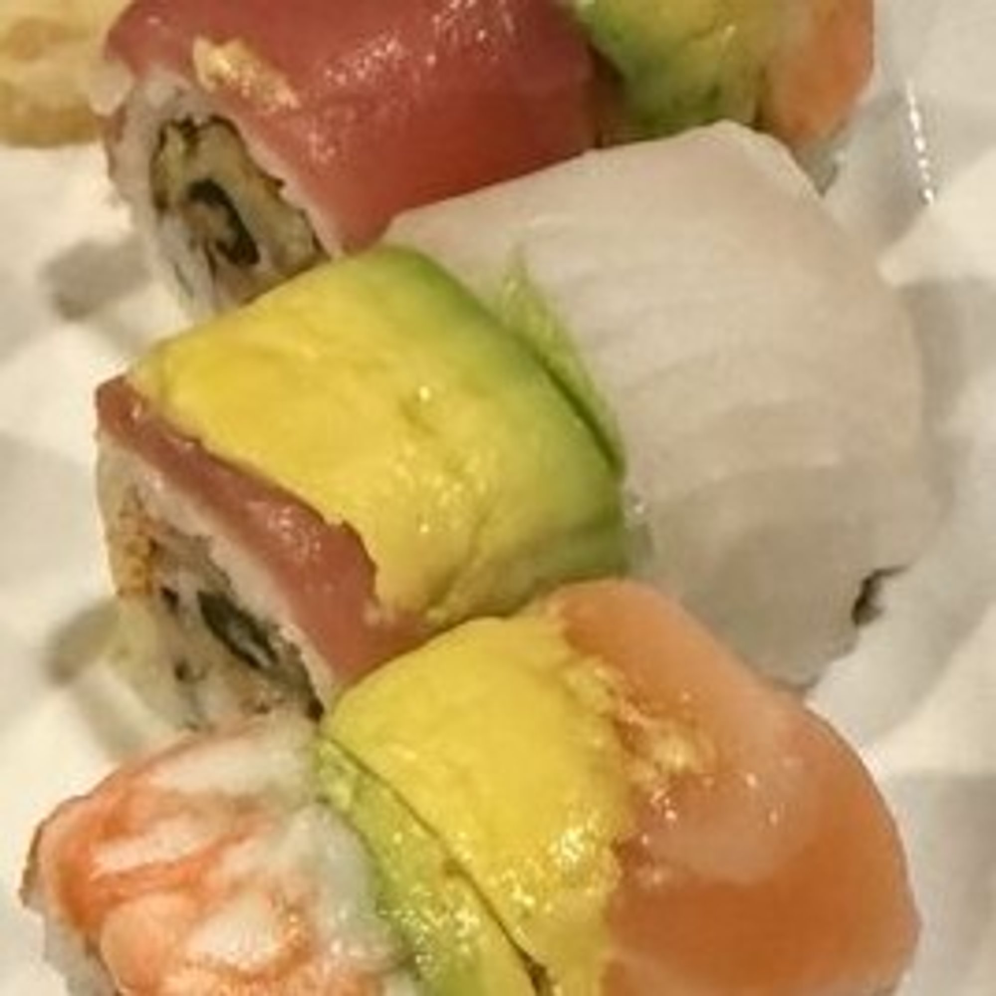 SR10. Rainbow Roll - Crab stick, avocado, cucumber with tuna, salmon, shrimp, white fish & masago...